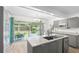 Bright kitchen with granite counters, stainless steel appliances, and a seamless view of the backyard at 1226 Se 9Th Ave, Ocala, FL 34471