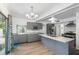 Open kitchen with granite countertops, an island, and gray cabinets, seamlessly blending style and functionality at 1226 Se 9Th Ave, Ocala, FL 34471