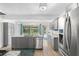 Bright eat-in kitchen featuring gray cabinets, stainless steel appliances, and an island with breakfast bar at 1226 Se 9Th Ave, Ocala, FL 34471