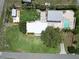 This aerial view features the detached shed, barn, fenced pool, and main home at 1423 Spruce N Rd, Lakeland, FL 33809