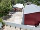 This beautiful aerial view captures a spacious home with a large shop and fenced yard at 1423 Spruce N Rd, Lakeland, FL 33809