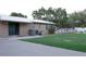 Spacious backyard featuring lush green grass, mature trees, and a newly painted white fence at 1423 Spruce N Rd, Lakeland, FL 33809