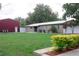 Exterior view of house and shed on a large lot, well-maintained lawn and mature landscaping at 1423 Spruce N Rd, Lakeland, FL 33809