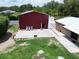 This aerial view of the barn and the backyard patio shows the open entrance to this unique space at 1423 Spruce N Rd, Lakeland, FL 33809