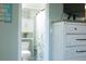 Inviting bathroom with storage cabinet, and leafy pattern shower curtain at 1423 Spruce N Rd, Lakeland, FL 33809