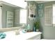 This charming bathroom features decorative accents, a large mirror, and a pristine white vanity at 1423 Spruce N Rd, Lakeland, FL 33809