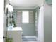 Nautical style bathroom features a decorative mirror, white vanity, and window with white shutters at 1423 Spruce N Rd, Lakeland, FL 33809