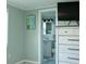 Bedroom with attached bathroom featuring coastal-themed decorations and a chest of drawers with a TV at 1423 Spruce N Rd, Lakeland, FL 33809