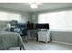 Bright bedroom featuring a bed, a desk with multiple monitors, and lots of natural light from windows at 1423 Spruce N Rd, Lakeland, FL 33809