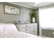 Sunlit bedroom showcases a decorative dresser and harmonious decor at 1423 Spruce N Rd, Lakeland, FL 33809