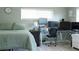 Bedroom with a bed, desk with multiple computer monitors, and natural light from two windows at 1423 Spruce N Rd, Lakeland, FL 33809