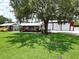 Charming home featuring a well-manicured lawn and spacious red-roofed building at 1423 Spruce N Rd, Lakeland, FL 33809