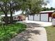 Charming home featuring a well-manicured lawn and spacious red-roofed building at 1423 Spruce N Rd, Lakeland, FL 33809