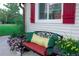 Charming front porch with cozy bench, colorful flowers, and cheerful decor at 1423 Spruce N Rd, Lakeland, FL 33809
