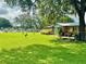 Well-maintained front yard with lush green grass, mature trees, and inviting curb appeal at 1423 Spruce N Rd, Lakeland, FL 33809