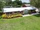 Inviting home showcasing well-manicured lawn and decorative garden bed at 1423 Spruce N Rd, Lakeland, FL 33809