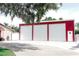 Spacious detached garage with multiple roll-up doors and ample parking space at 1423 Spruce N Rd, Lakeland, FL 33809