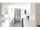 Contemporary kitchen featuring white cabinets, stainless steel appliances, quartz countertops, and gray wood floors at 1423 Spruce N Rd, Lakeland, FL 33809