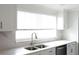 Updated kitchen featuring white cabinets, stainless steel appliances, quartz countertops, and a stainless steel sink at 1423 Spruce N Rd, Lakeland, FL 33809