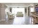 Bright and spacious living room with hardwood floors, white furniture, and nautical decor at 1423 Spruce N Rd, Lakeland, FL 33809