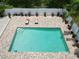 Birds eye view of pool with brick trim, outdoor lounge furniture, and white fencing at 1423 Spruce N Rd, Lakeland, FL 33809