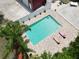 Aerial view of backyard pool with brick trim and two lounge chairs at 1423 Spruce N Rd, Lakeland, FL 33809