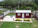 View of the backyard shed with a white fence and landscaping surrounding it at 1423 Spruce N Rd, Lakeland, FL 33809