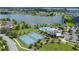 Beautiful aerial view of community pool, tennis courts, and waterfront property at 2283 Geneva Dr, Lakeland, FL 33805