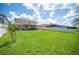 Expansive backyard with a well-manicured lawn, patio, and privacy fence at 2283 Geneva Dr, Lakeland, FL 33805
