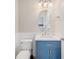 Stylish half-bath with a modern vanity, oval mirror, and wainscoting at 2283 Geneva Dr, Lakeland, FL 33805