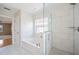 Bright bathroom with tile flooring, soaking tub, walk-in shower, and recessed lighting at 2283 Geneva Dr, Lakeland, FL 33805