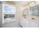 Bright bathroom featuring double sinks, new vanities, framed mirrors, and new lighting at 2283 Geneva Dr, Lakeland, FL 33805
