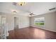 Upstairs bonus room with views of a lake, hardwood floors, ceiling fan, and neutral paint at 2283 Geneva Dr, Lakeland, FL 33805