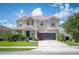 Charming two-story home with a well-manicured lawn, two-car garage and welcoming front porch at 2283 Geneva Dr, Lakeland, FL 33805