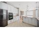 Open kitchen with white cabinets, stone countertops, stainless steel appliances, and tile floors at 2283 Geneva Dr, Lakeland, FL 33805