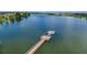 Picturesque view of the lake with a wooden dock, perfect for waterfront enjoyment at 2283 Geneva Dr, Lakeland, FL 33805