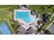 Aerial view of a community pool area with a large pool, lounge chairs, and a playground at 2283 Geneva Dr, Lakeland, FL 33805