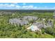 Aerial view of the condo community showcases multiple buildings, pool area, and surrounding green landscape at 3175 Feltrim Pl # 405, Kissimmee, FL 34747