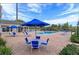 Community pool area with blue umbrellas and lounging chairs provides a relaxing space for residents at 3175 Feltrim Pl # 405, Kissimmee, FL 34747