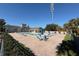 Community pool featuring lounging area and greenery, offering a relaxing space for residents at 3175 Feltrim Pl # 405, Kissimmee, FL 34747