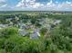 Aerial view of a lovely home with a screened-in pool in a quiet, tree-filled neighborhood at 3952 Laurel Branch Dr, Lakeland, FL 33810