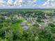 Picturesque aerial view of a home featuring a screened-in pool amidst a peaceful, green community at 3952 Laurel Branch Dr, Lakeland, FL 33810