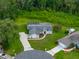 Aerial view showcases a well-maintained property with a screened pool and lush backyard at 3952 Laurel Branch Dr, Lakeland, FL 33810