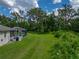View of the backyard with the screened in pool and lush green foliage surrounding the property at 3952 Laurel Branch Dr, Lakeland, FL 33810