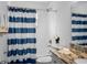 Bathroom with blue and white striped shower curtain and granite countertop at 3952 Laurel Branch Dr, Lakeland, FL 33810