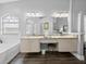 Well-lit bathroom with a double vanity, a large mirror and a jacuzzi tub at 3952 Laurel Branch Dr, Lakeland, FL 33810