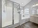 Bathroom featuring a glass shower, large tub, wood-look floors, and an arched window at 3952 Laurel Branch Dr, Lakeland, FL 33810