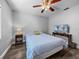 Charming bedroom with hardwood floors, ceiling fan, and entertainment center at 3952 Laurel Branch Dr, Lakeland, FL 33810