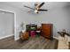View of a bedroom with hardwood floors, ceiling fan, and adjacent walk-in closet at 3952 Laurel Branch Dr, Lakeland, FL 33810