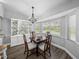 Bright dining area with a chandelier, complemented by lots of natural light from the window at 3952 Laurel Branch Dr, Lakeland, FL 33810